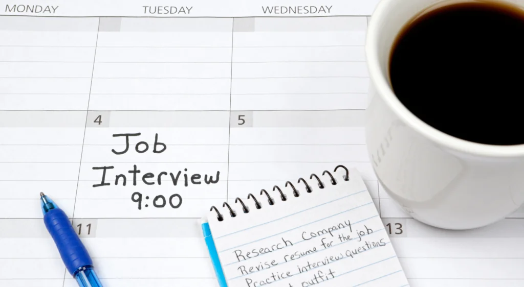 Calendario con una entrevista de trabajo a las 9:00 y una libreta con notas de preparación