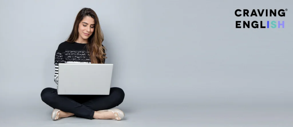 Woman sitting on the floor typing on her laptop